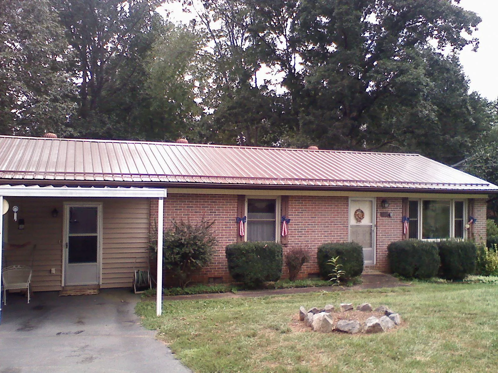 Bronze metal roof and carport on a brick ranch home — Roof Repair work by our crew in East Rockaway